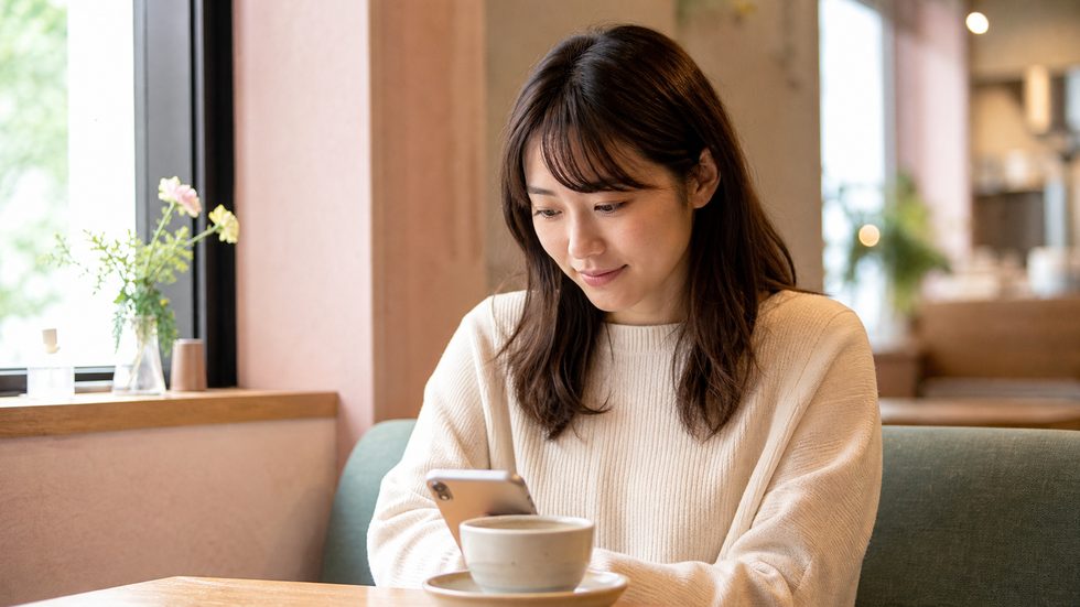 チャットレディを始めようか検討している女性のイメージ（スマホで情報収集する様子）